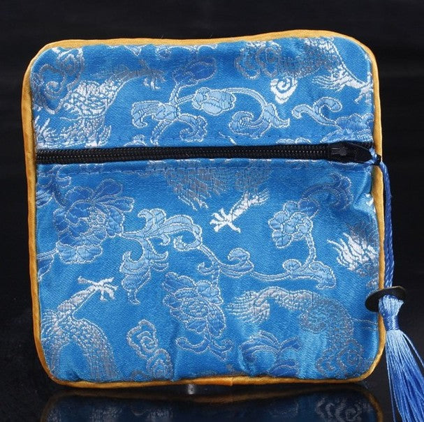 Mahjong dice and coin bag for organizing and protecting dice, betting coins, and other American mahjong accessories.