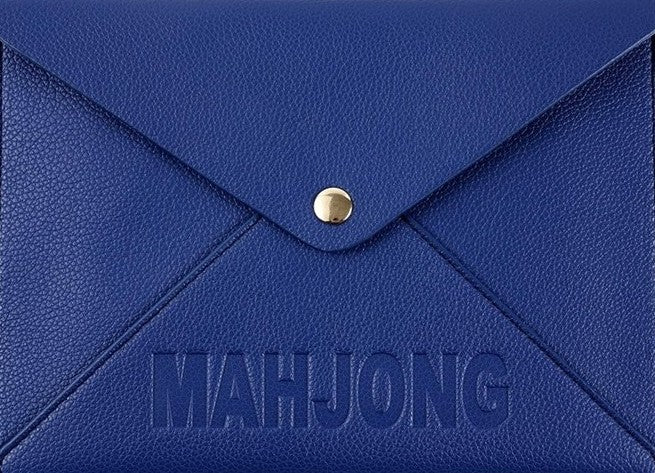 Premium leather NMJL playing card clutch with a secure snap closure, designed to protect the Official National Mah Jongg League playing card. Available in navy, emerald green, blush pink, and bright pink for stylish storage, travel, league play, and game nights.